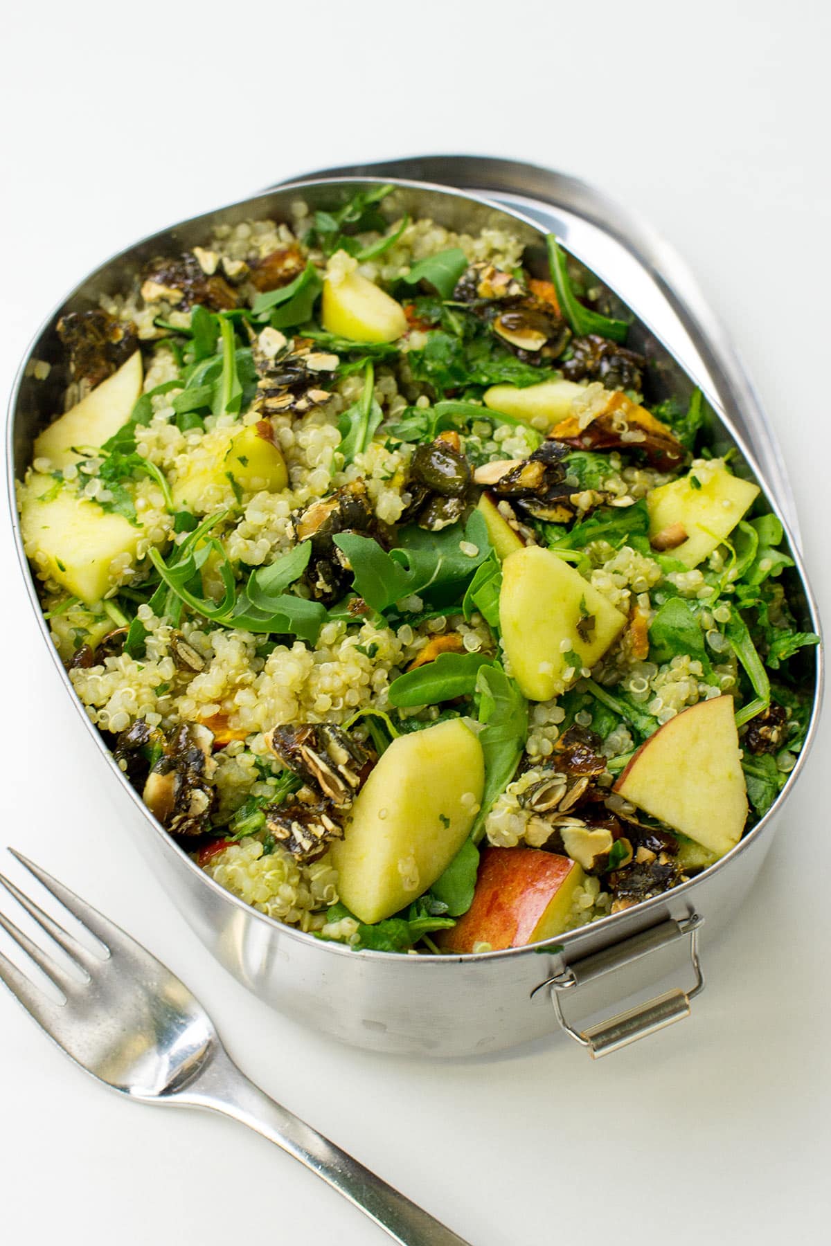 A metal bowl of Roasted Pumpkin Quinoa Salad with Rocket Pesto