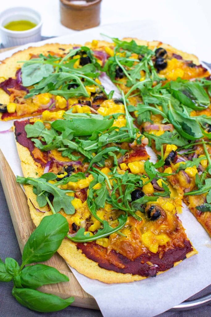 The pizza is served on the paper on a chopping board on a towel with olive oil, salt and basil #salt #tomato paste | 