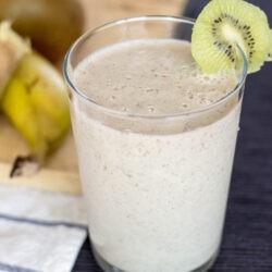 Spicy Kiwi Banana Smoothie is in the glass with a slice of kiwi | Hurry The Food Up