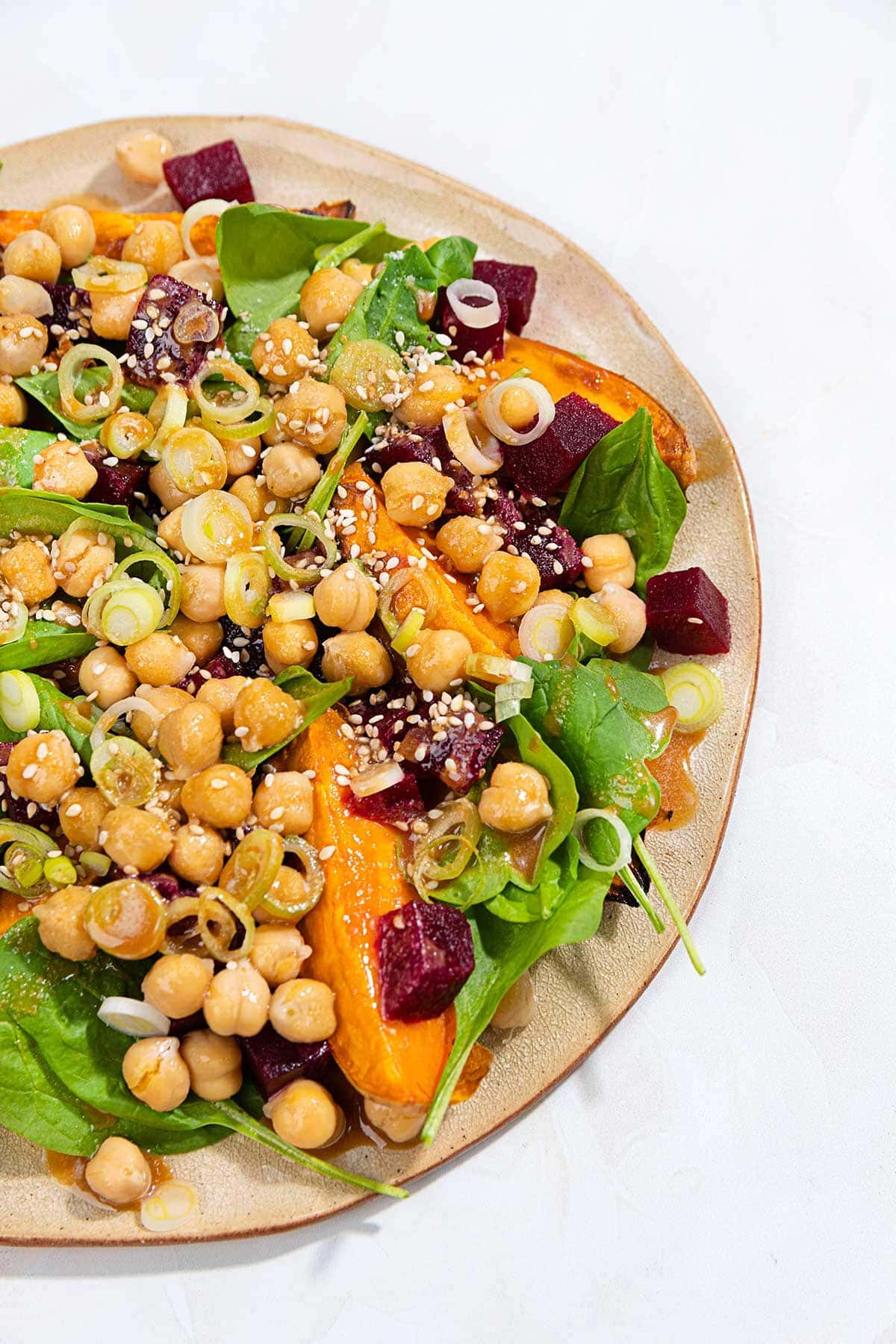 Salad is served on the plate that is on the white surface | Hurry The Food Up