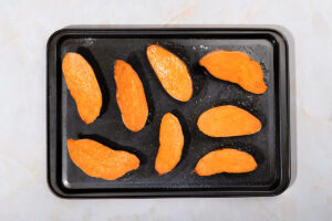 Slices of sweet potatoes are laid on the tray for baking | Hurry The Food Up