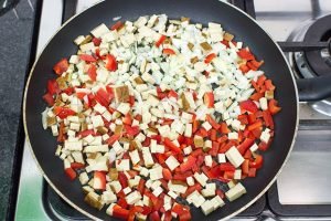 Speedy Vegan Burrito – Packed with Protein - tofu, onion and pepper are frying in the pan #onion #vegetarian | 