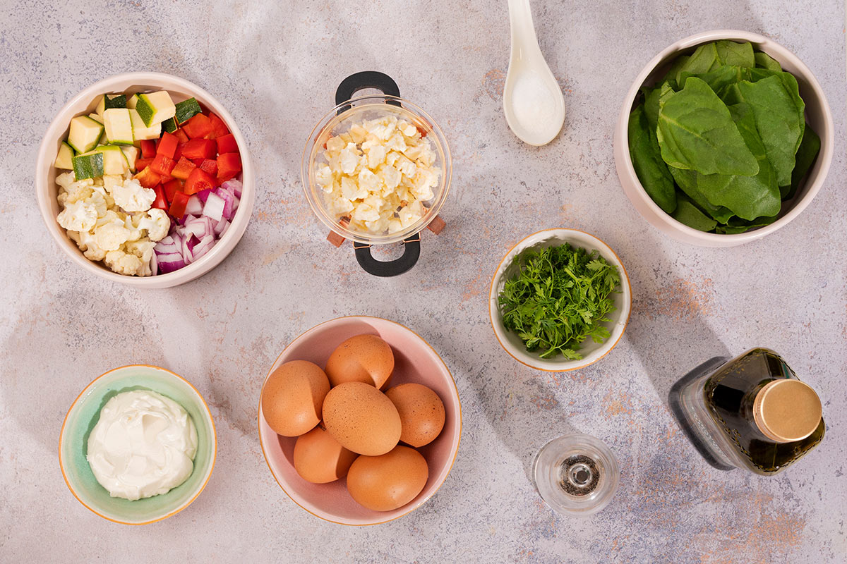 Veggie Frittata ingredients like veggies, eggs, cream cheese, spinach, feta cheese, fresh herbs etc. | Hurry The Food Up